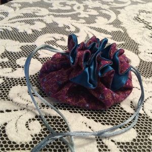 Drawstring travel jewelry pouch with 8 sections.